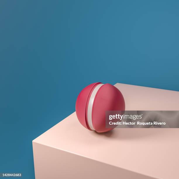 3d render of red balls on top of pink cube isolated on blue background - leading edge stock pictures, royalty-free photos & images