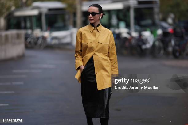 Mary Leest seen wearing a prada bag, a yellow leather blouse and a black leather skirt, outside Mame Kurogouchi during Paris Fashion Week on...