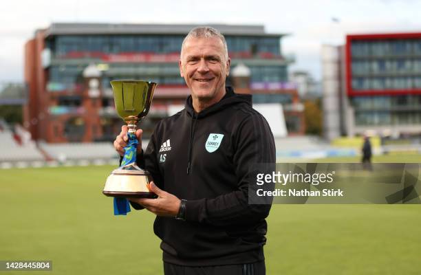 Alec Stewart of Surrey poses with the LV= Insurance County Championship Trophy after the match between Lancashire and Surrey at Emirates Old Trafford...