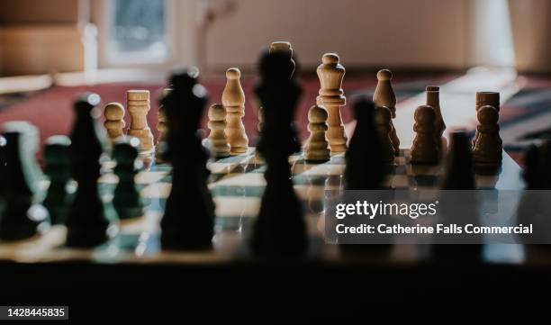 close-up of a chessboard, one side is in the foreground while the focus remains on the white team. - scoreboard stock pictures, royalty-free photos & images