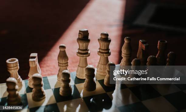 close-up of a chessboard, focus on the king and queen - strategy stock pictures, royalty-free photos & images