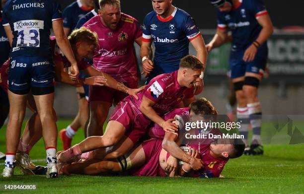 Lewis Pearson of Exeter Chiefs celebrates with his team mates after scoring his side's third try during the Premiership Rugby Cup match between...