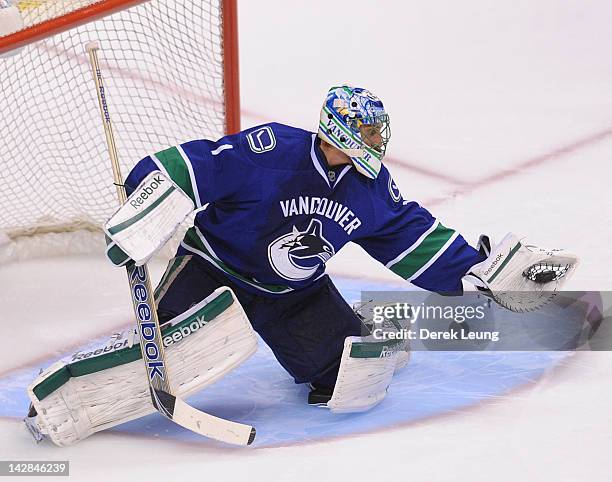 Roberto Luongo of the Vancouver Canucks makes a glove save against the Los Angeles Kings in Game One of the Western Conference Quarterfinals during...