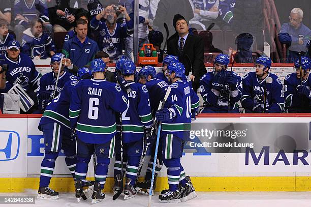 Coach Alain Vigneault of the Vancouver Canucks looks up at the scoreboard during a time out in the game against the Los Angeles Kings in Game One of...