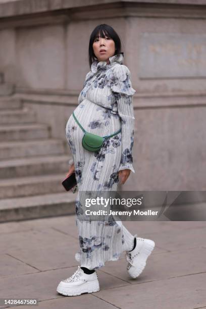 Susie Lau seen wearing a colorful dress with a Loewe bag, outside Halpern Show during London Fashion Week, on September 18, 2022 in London, England.