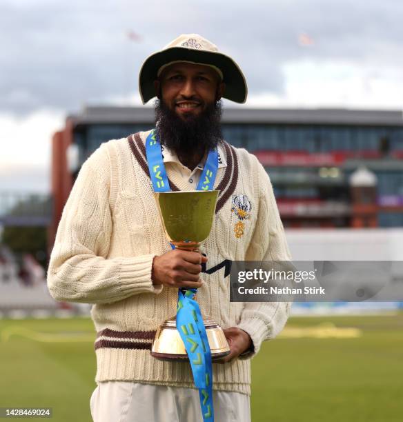 Hashim Amla of Surrey with the LV= Insurance County Championship Division One Trophy after the match between Lancashire and Surrey at Emirates Old...