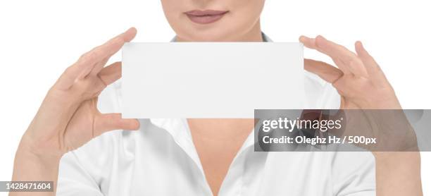 woman with a mockup in her hand on a white background isolate - business card mockup imagens e fotografias de stock