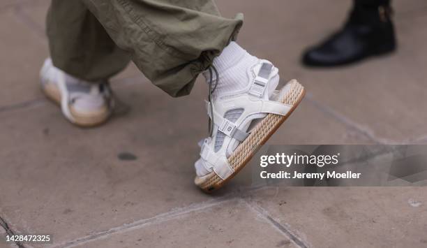 Fashion week guest seen wearing a look with Dior shoes, outside Halpern Show during London Fashion Week, on September 18, 2022 in London, England.
