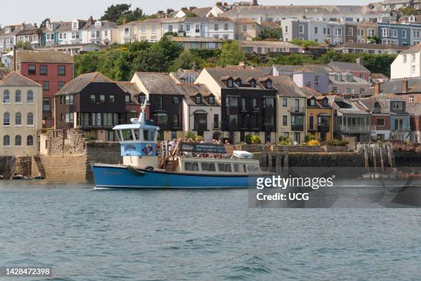 Falmouth, Cornwall, England, UK, Passenger ferry passing waterfront homes , Falmouth Harbor, Cornwall, UK.