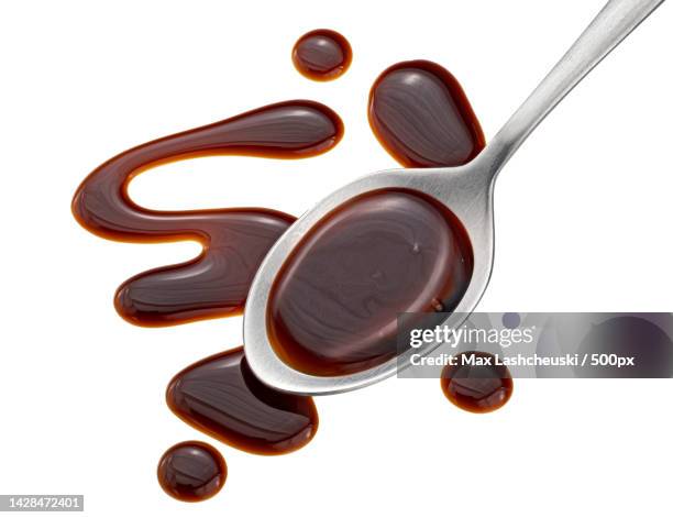 balsamic sauce in spoon isolated on white background,top view - syrup splash stock pictures, royalty-free photos & images