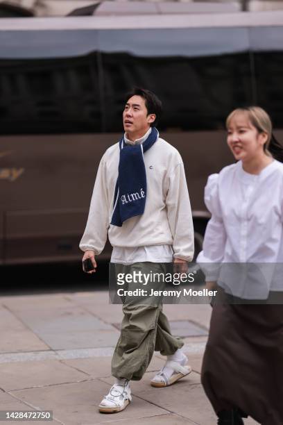 Fashion week guest seen wearing a look with Dior shoes, outside Halpern Show during London Fashion Week, on September 18, 2022 in London, England.