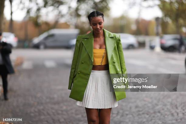 Flora Coquerel seen wearing a green leather jacket and a pleated skirt, outside Victoria/Tomas during Paris Fashion Week on September 27, 2022 in...