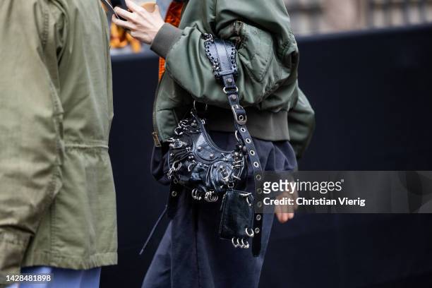 Guest wears Balenciaga bag outside Undercover during Paris Fashion Week - Womenswear Spring/Summer 2023 : Day Three on September 28, 2022 in Paris,...