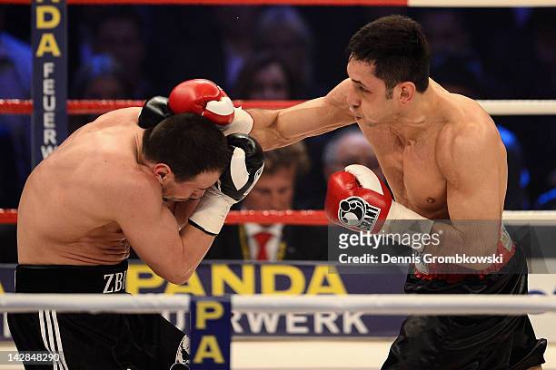 Sebastian Zbik of Germany and Felix Sturm of Germany exchange punches during their WBA middleweight world championship fight at Lanxess Arena on...