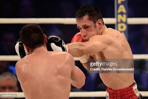 Felix Sturm of Germany hits Sebastian Zbik of Germany during their WBA middleweight world championship fight at Lanxess Arena on April 13, 2012 in...