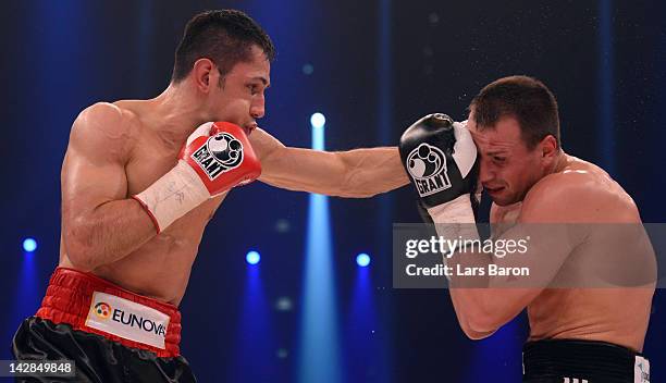 Felix Sturm of Germany punshes Sebastian Zbik of Germany during their WBA World Championship middleweight fight at Lanxess Arena on April 13, 2012 in...