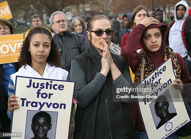 Left to right, Jussara Sequeira, Donna Pomponio and Neomi Nunez, all from Notre Dame Education Center in South Boston, react to a recording in Texas...