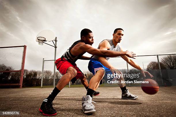 one on one basketball game. - basketball shoe stock pictures, royalty-free photos & images