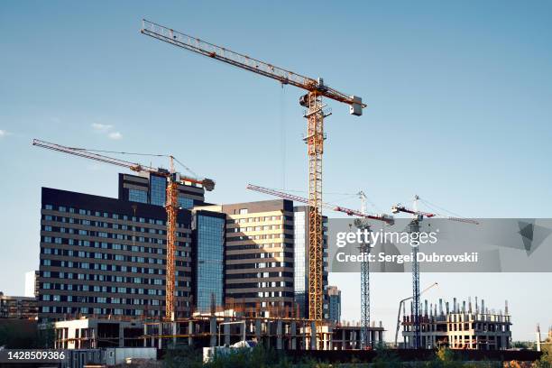 tower cranes and high-rise buildings silhouettes - wide stock pictures, royalty-free photos & images