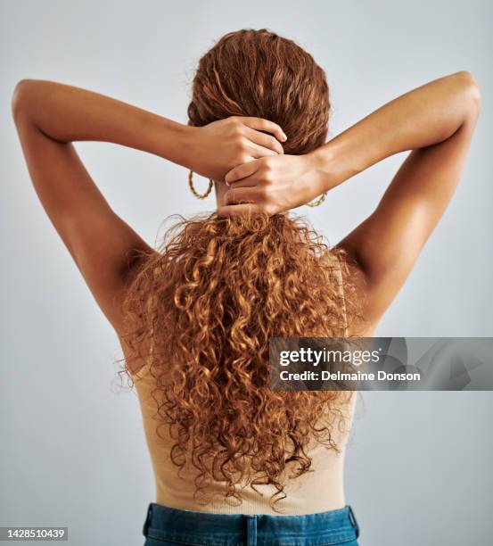 hair, hands and beauty with a woman and her curly hairstyle in studio on a gray background. salon, shampoo and cosmetics with a female model taking care of her strong and colorful curls inside - long gray hair stock pictures, royalty-free photos & images