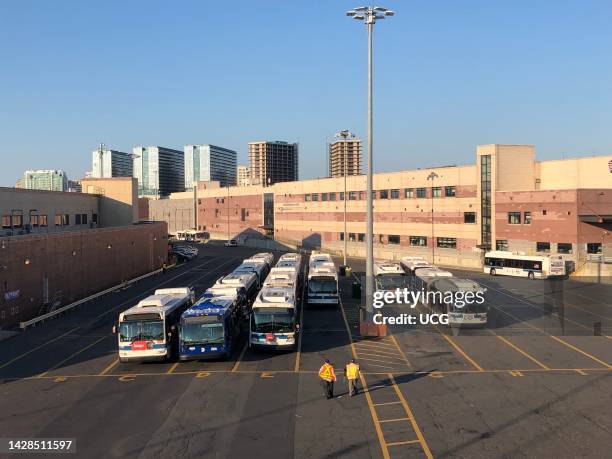 Bus station and depot, Willets Point, with new apartment buildings in Flushing in the background, Queens, New York.