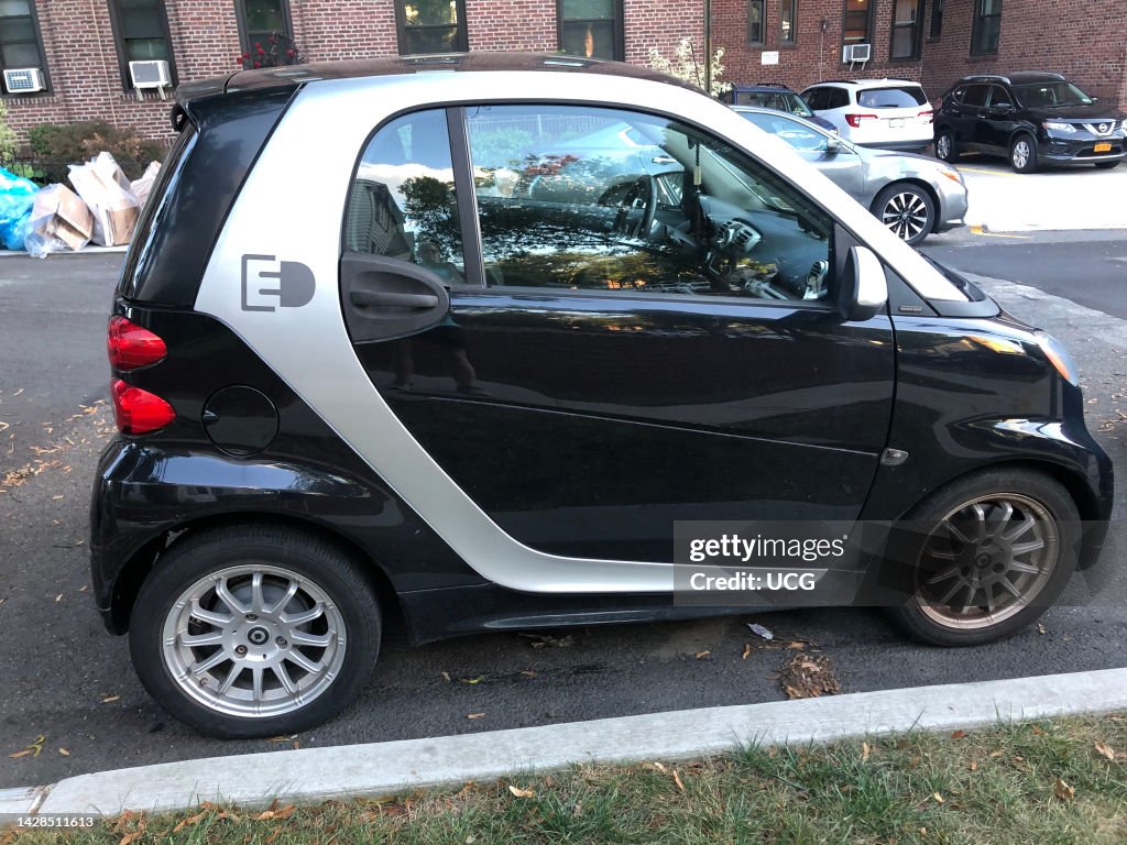 Compact Electric car parked on street, Queens, New York