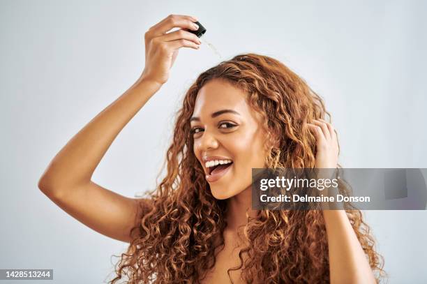 natural hair, essential oil and black woman with healthy growth in studio background with mock up for beauty, salon and product. african girl portrait applying serum for hair care health with mockup - natural black hair stock pictures, royalty-free photos & images