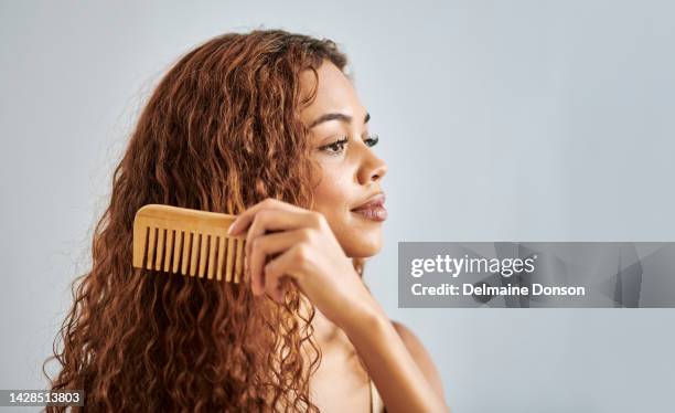 black woman, beauty and hair comb on a studio gray background mockup. natural, curly and hispanic haircare model girl with luxury salon cosmetic healthy hairstyle care for cool and fresh look. - hair conditioner stockfoto's en -beelden