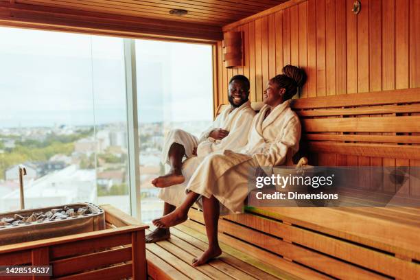 wealthy couple enjoying is sauna - kuuroord stockfoto's en -beelden