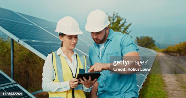 solar panel, engineer and talk with tablet for project data analysis with eco contractor team. construction, sustainability and renewable energy development with professional technician. - low carbon technology stockfoto's en -beelden