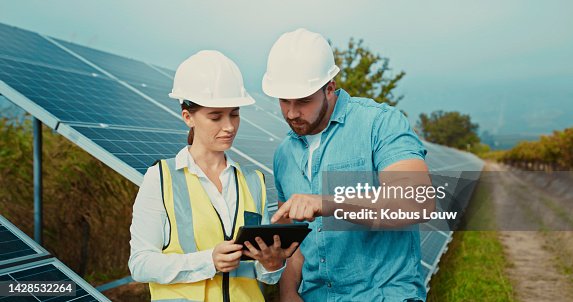 Solar panel, engineer and talk with tablet for project data analysis with eco contractor team. Construction, sustainability and renewable energy development with professional technician. Solar panel, engineer and talk with tablet for project data analysis with eco contractor team. Construction, sustainability and renewable energy development with professional technician.