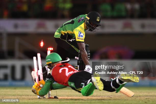 Rahmanullah Gurbaz of Guyana Amazon Warriors attempts to run-out Shamarh Brooks of Jamaica Tallawahs during the Qualifier 2 match between Guyana...