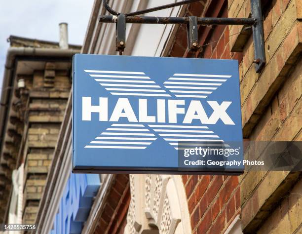 Wall hanging sign for Halifax bank branch on High Street, UK.