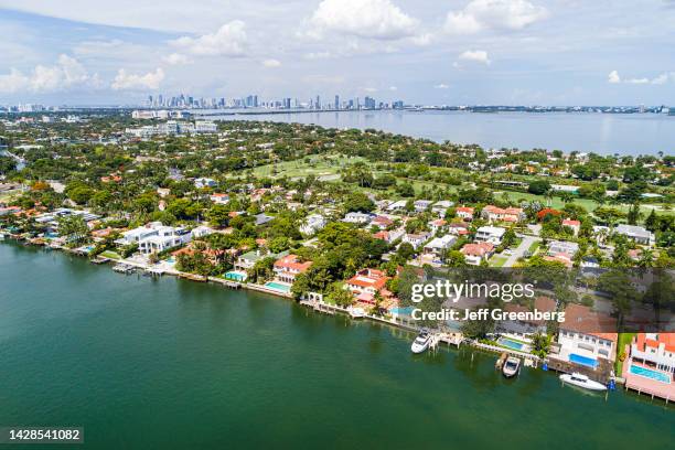 Miami Beach, Florida, aerial view, Indian Creek La Gorce Island Country Club, waterfront mansions estates homes and city skyline.