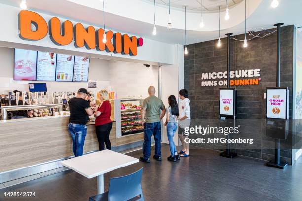 Miccosukee Indian Reservation, Florida Everglades, Service Plaza, Dunkin' Donuts customers using touch screen kiosk.
