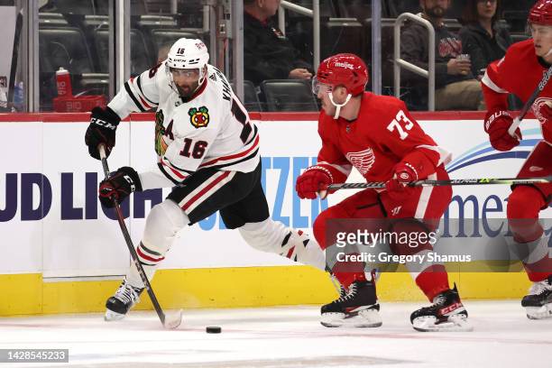 Jujhar Khaira of the Chicago Blackhawks tries to control the puck next to Adam Erne of the Detroit Red Wings during the first period at Little...