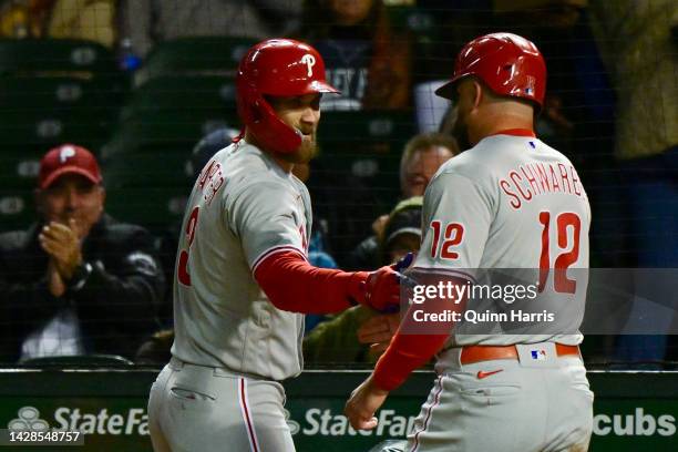 Bryce Harper and Kyle Schwarber of the Philadelphia Phillies celebrate after scoring in the third inning against the Chicago Cubs at Wrigley Field on...