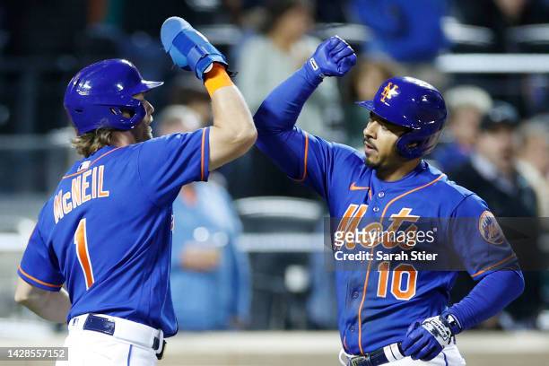 Eduardo Escobar celebrates with Jeff McNeil of the New York Mets after hitting a two-run home run during the seventh inning against the Miami Marlins...