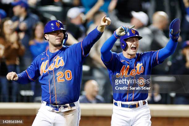 Pete Alonso and Brandon Nimmo of the New York Mets react after scoring on an infield single to tie the game hit by Eduardo Escobar during the eighth...