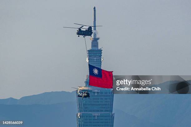 Hoists a Taiwan flag fly across the city during a rehearsal ahead of Taiwan National Day celebrations on September 29, 2022 in Taipei, Taiwan. The...