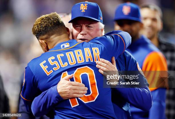 Eduardo Escobar of the New York Mets hugs manager Buck Showalter after hitting a walk-off RBI single during the tenth inning against the Miami...