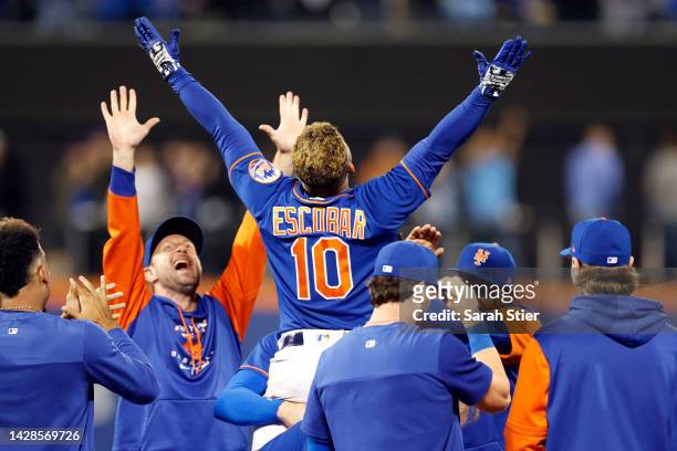 Eduardo Escobar of the New York Mets reacts with teammates after hitting a walk-off RBI single during the tenth inning against the Miami Marlins at...