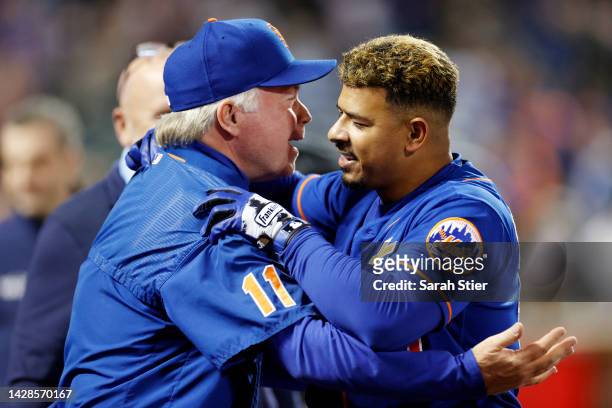 Eduardo Escobar of the New York Mets hugs Manager Buck Showalter after hitting a walk-off RBI single during the tenth inning against the Miami...
