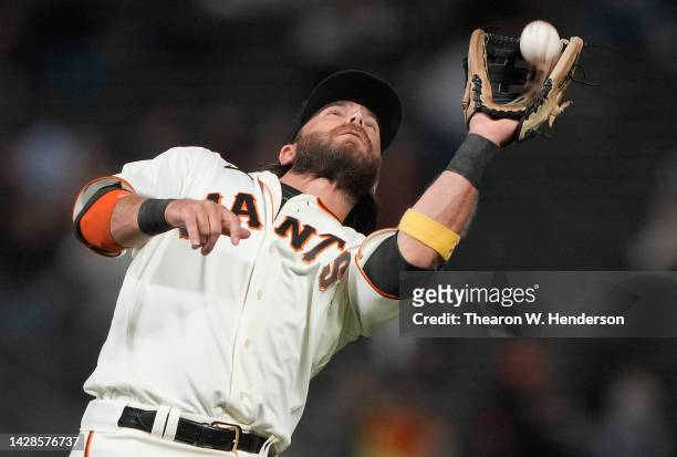 Brandon Crawford of the San Francisco Giants catches a pop-up on the infield off the bat of Elehuris Montero of the Colorado Rockies in the top of...