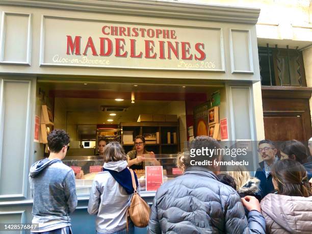customers at madeleine cake shop - biscuit france stock pictures, royalty-free photos & images