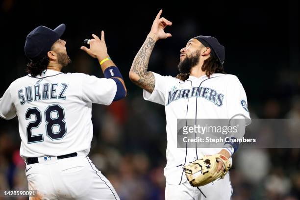 Eugenio Suarez and J.P. Crawford of the Seattle Mariners celebrate their 3-1 win against the Texas Rangers at T-Mobile Park on September 28, 2022 in...