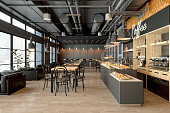 Empty Coffee Shop Interior With Wooden Tables, Coffee Maker, Pastries And Pendant Lights