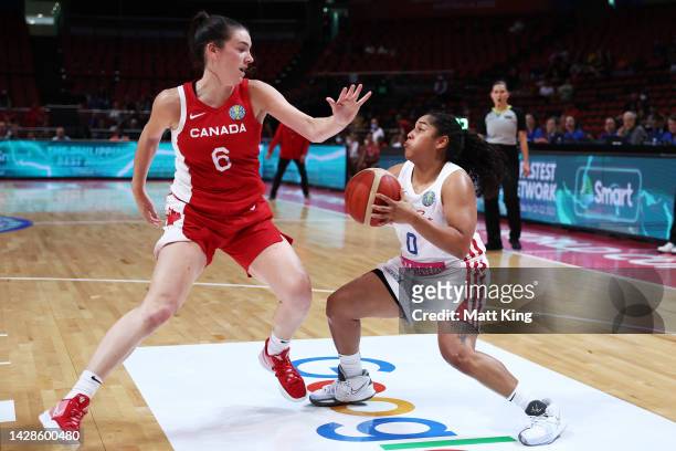 Jennifer O'Neill of Puerto Rico is challenged by Bridget Carleton of Canada during the 2022 FIBA Women's Basketball World Cup Group Canada match...