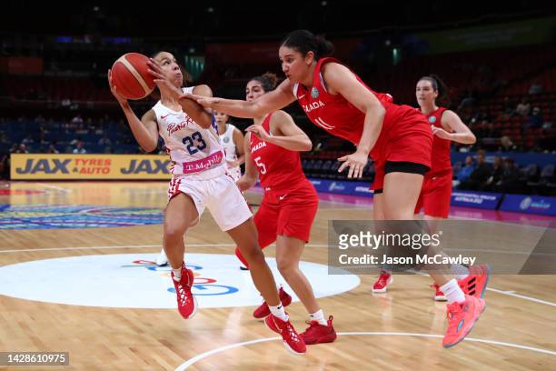 Trinity San Antonio of Puerto Rico drives to the basket under pressure from Natalie Achonwa of Canada during the 2022 FIBA Women's Basketball World...