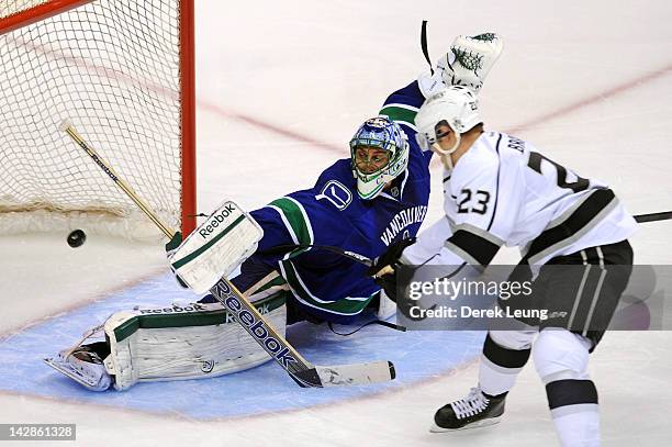 Dustin Brown of the Los Angeles Kings shoots the puck past Roberto Luongo of the Vancouver Canucks in Game Two of the Western Conference...